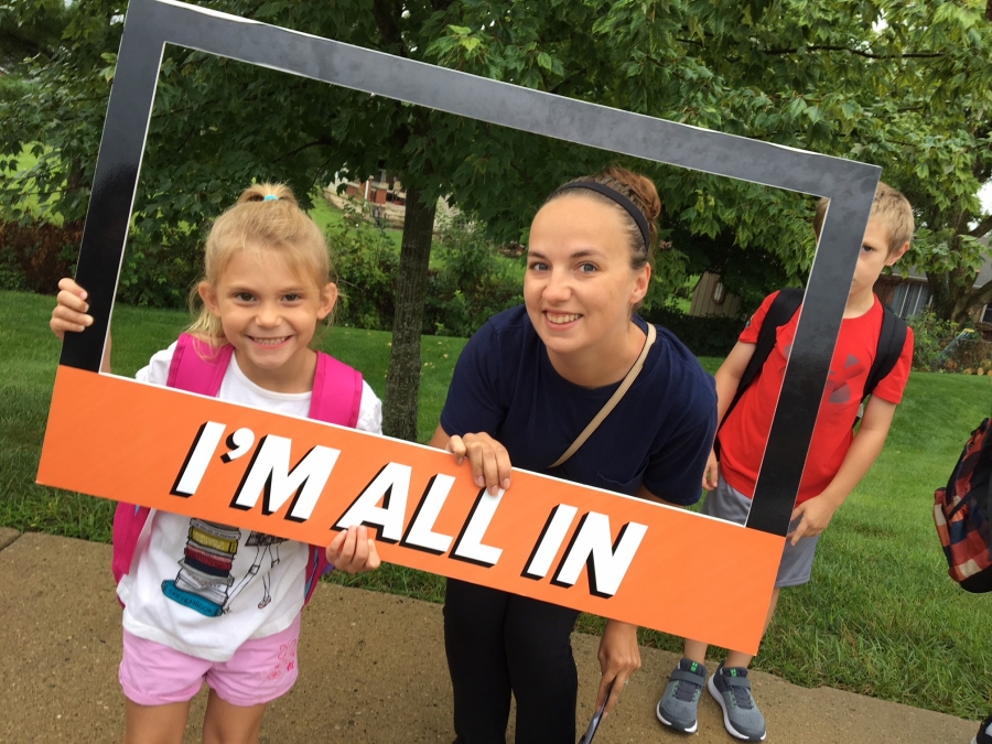 people holding a frame sign